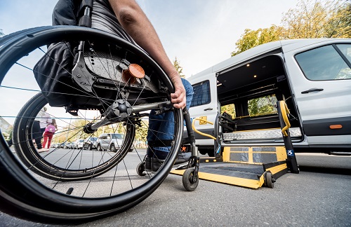 Man with wheelchair getting into car