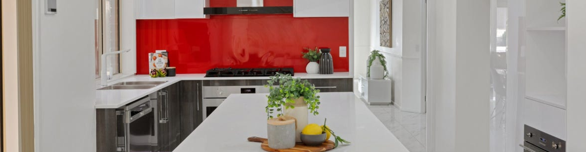 Modern white kitchen with red splashback