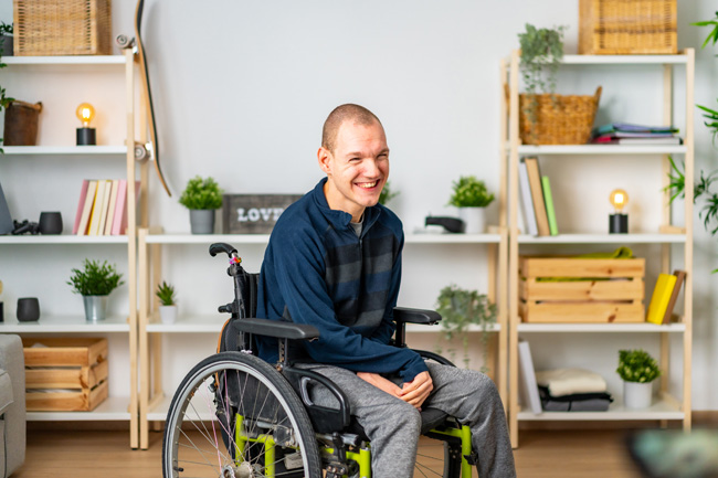 Happy man in wheelchair smiling in the living room