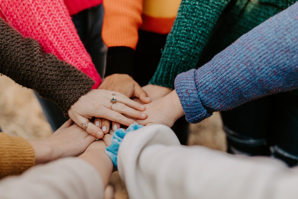 Multiple hands on top of each other representing team work