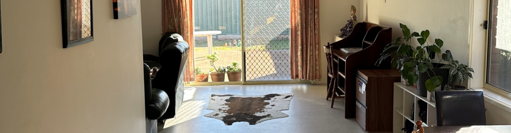 Rugby Street image with cowprint carpet and view of the backyard